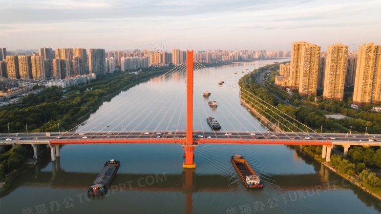 橙红斜拉桥航拍城市河景图片