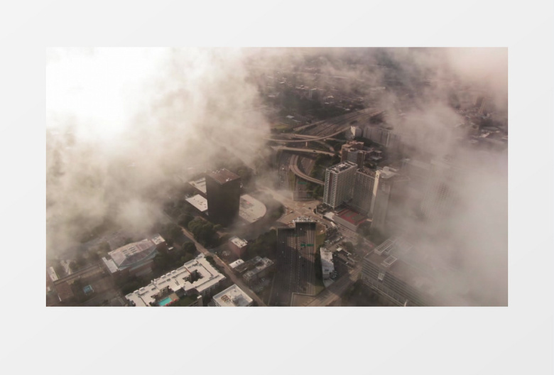 航拍云层笼罩下的城市建筑实拍视频素材